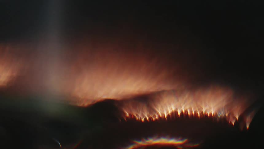 Blue torch flame heats coiled metal