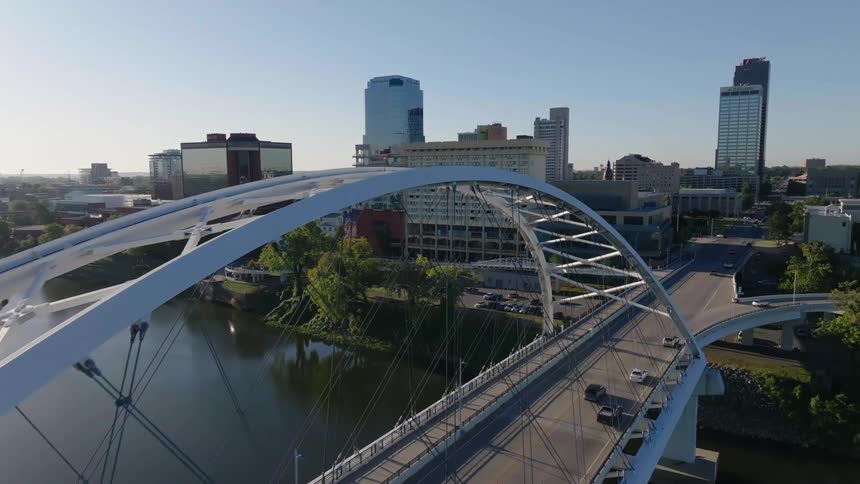 Landscape of a bridge moving cars and buildings in a metropolitan area on a sunny day