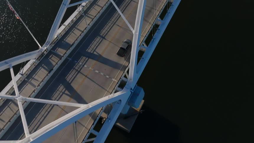 Aerial view of a bridge connecting to a metropolis