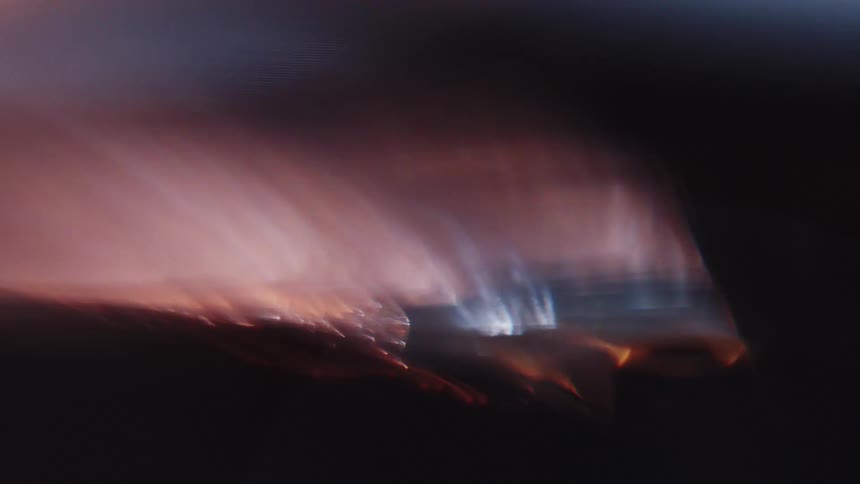 Extreme closeup of lights reflecting in the midst of abstract darkness
