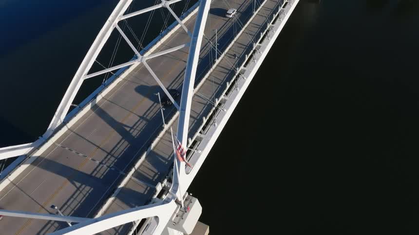Moving cars on a bridge in a metropolitan area during the day