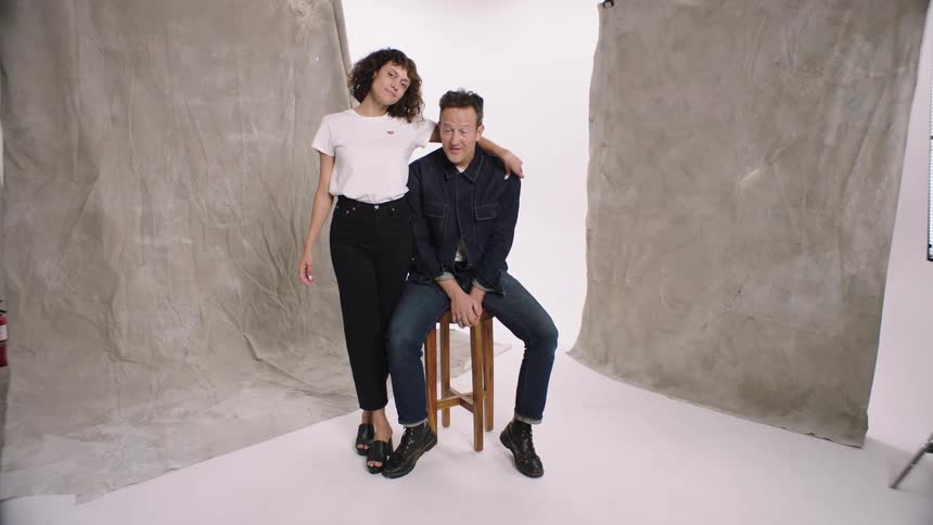 A man and woman pose in the studio