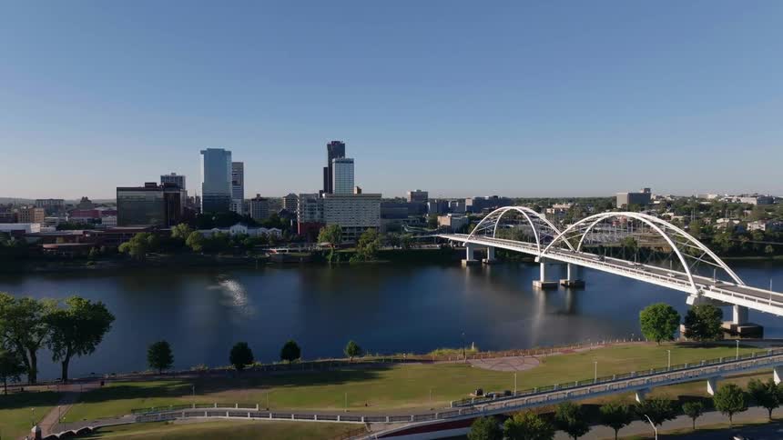 Bridge buildings and moving cars in a metropolitan area at midday