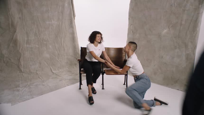 Man and two women sitting in a studio standing up and leaving