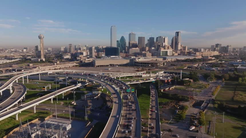 Traffic flows along highways nearing downtown on cloudy day