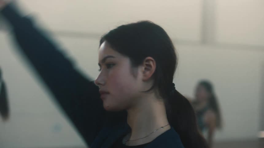 Portrait of a young woman stretching her arms backward