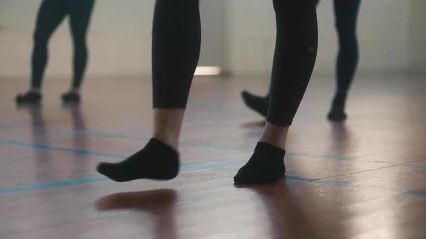Closeup on the legs of women performing a choreography with their right feet
