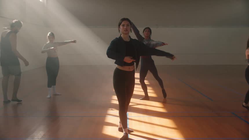 Teacher assisting his students in ballet spinning movements