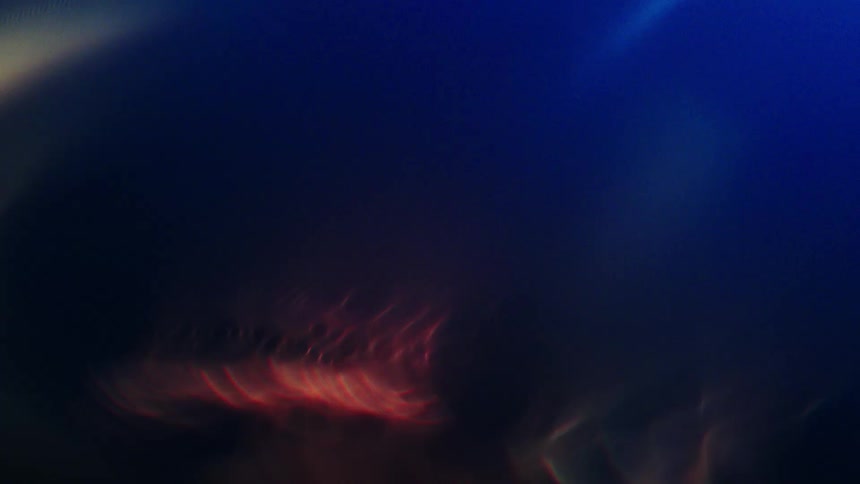 Extreme closeup of an abstract object with lights and reflections