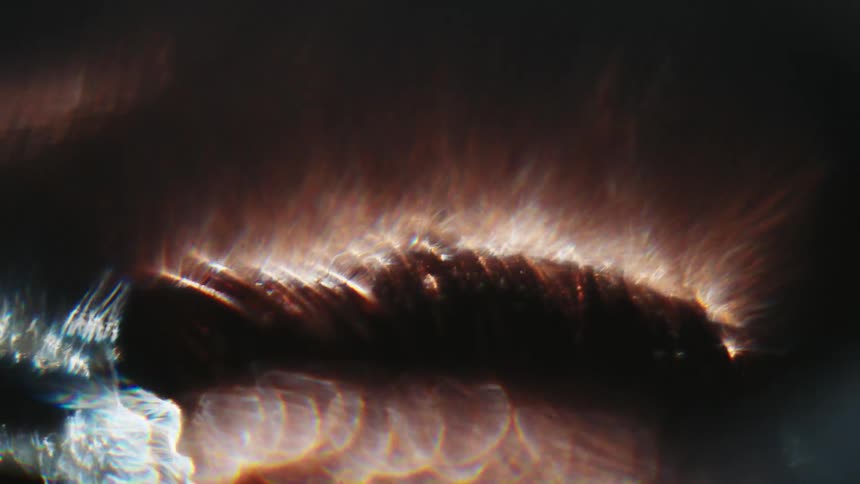 Extreme closeup of an abstract object with reflections of lights