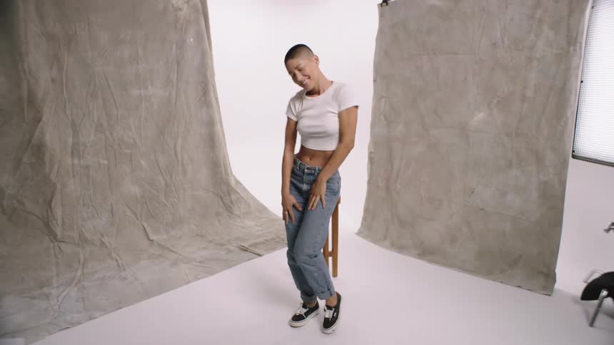Young happy woman with a buzz cut dancing