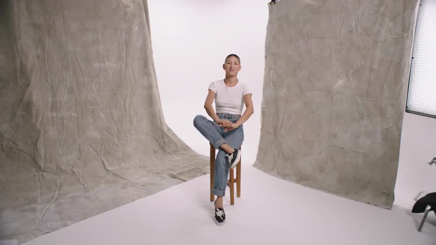 Woman sitting in a chair in a studio modeling