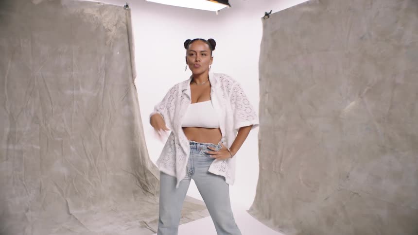 A young woman is dancing happily on a white background