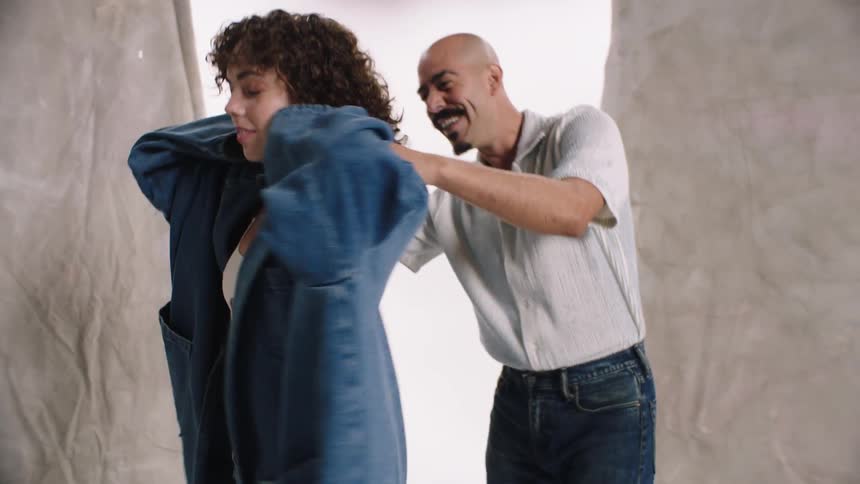 A man and a woman in a denim fashion shoot photo white cyc studio tansition