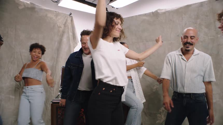 People dancing on set in front of a camera at midday