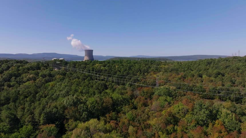 A power plant is past the forest
