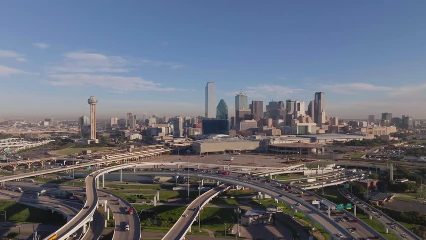 Aerial view of a highway next to the city at daytime
