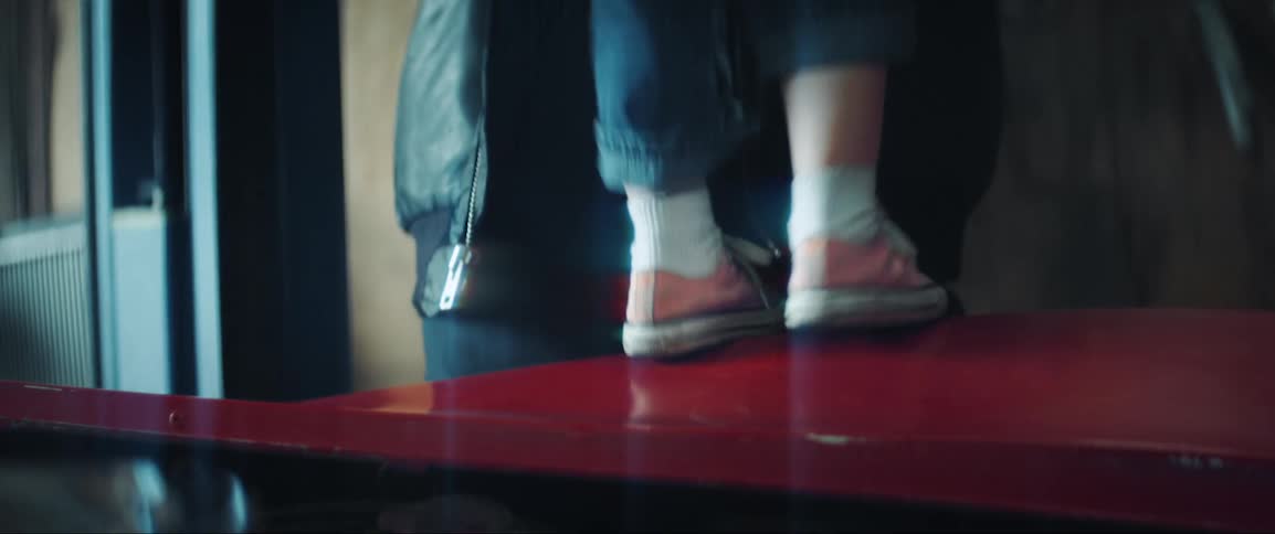 Little girl touching her fathers glasses as he picks her up and they walk out of the room