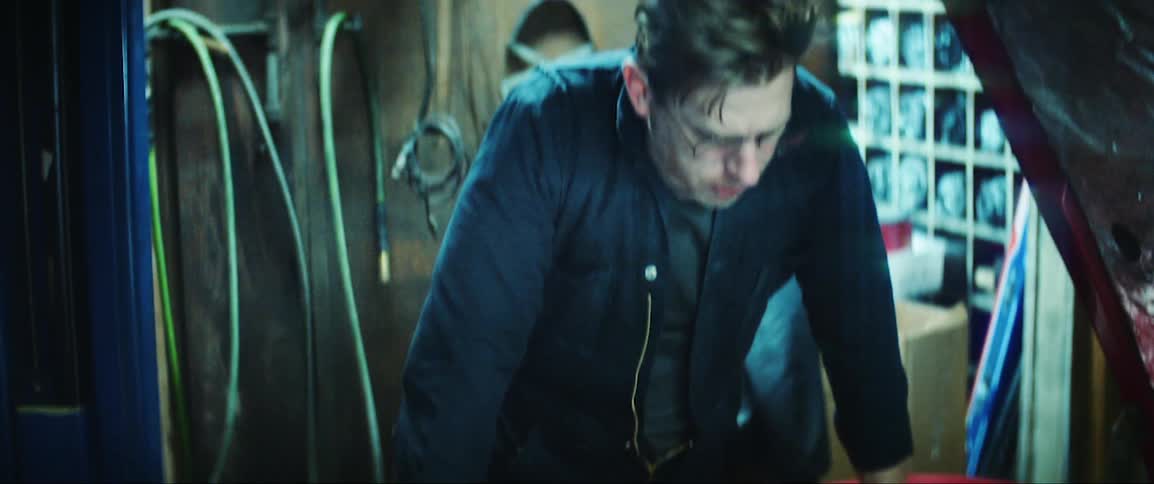 Mechanic opening the hood of a red car and checking it