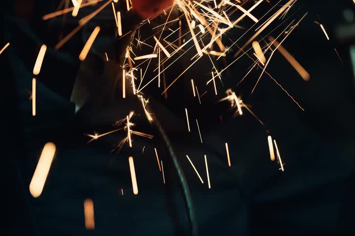 A woman wearing protective glasses using a cutting tool
