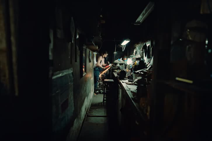 A woman using a power tool in a workshop