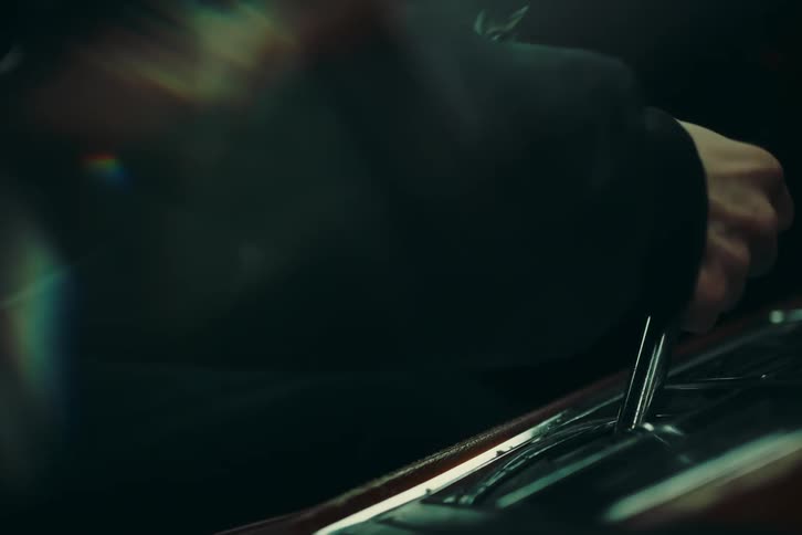 A hand changing the gear of the cars gearbox