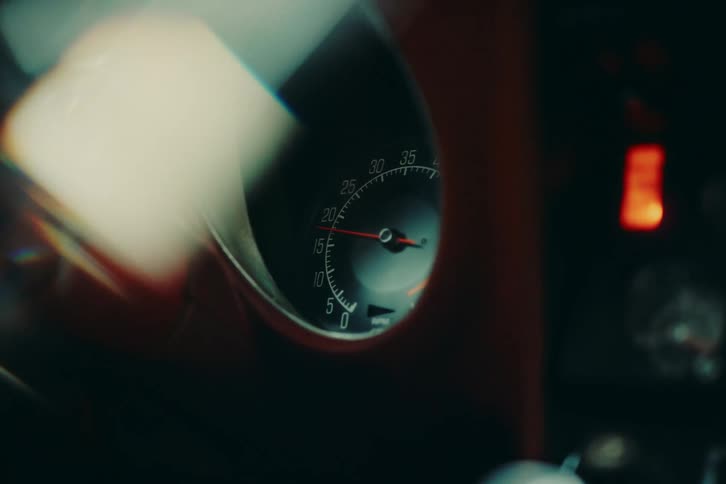 Closeup of hands starting a vehicle that is turning on