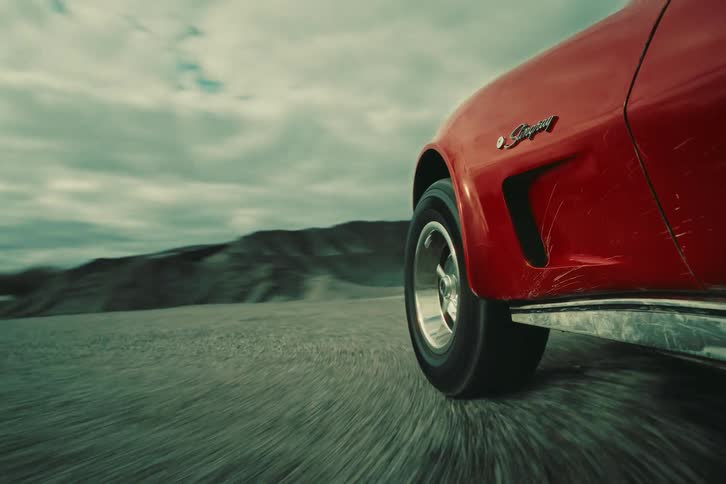 A car turning a curve on a gravel road