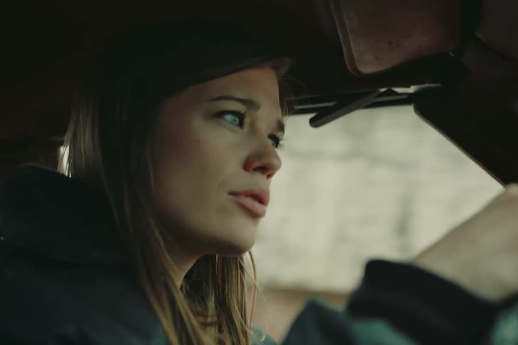 A clip of a woman driving a car