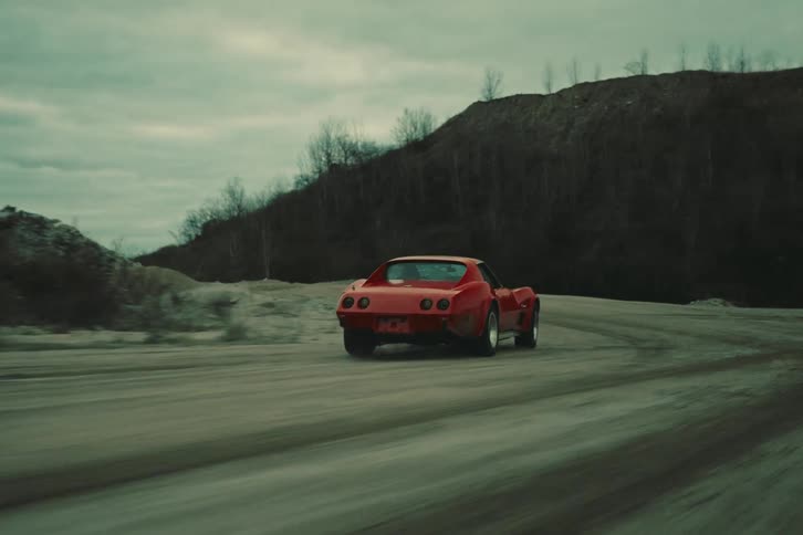Red sports car making a turn and braking