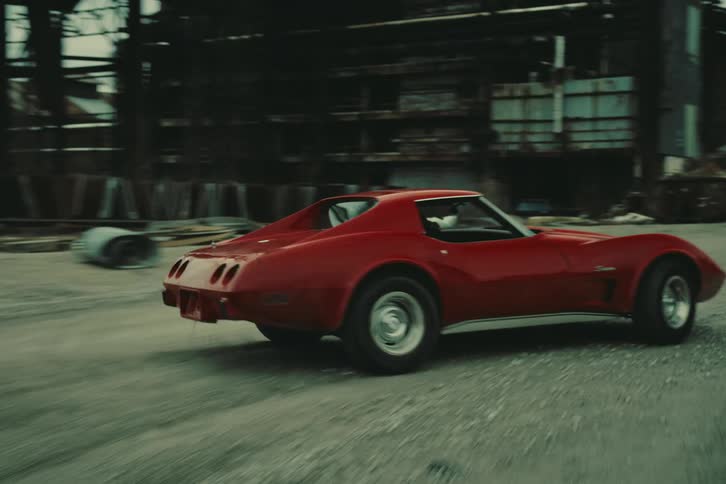Red classic sports car driving and taking curves