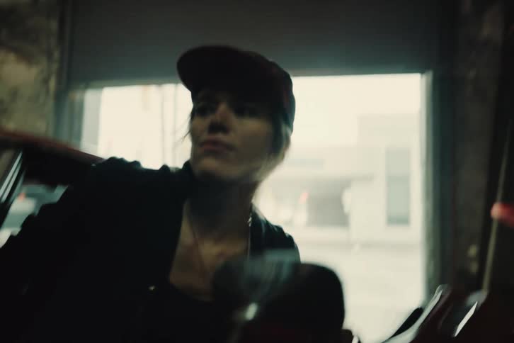 Femalemechanic gets out of car and examines car engine