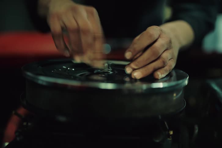 Close up of hands inspecting and fixing sports cars engine