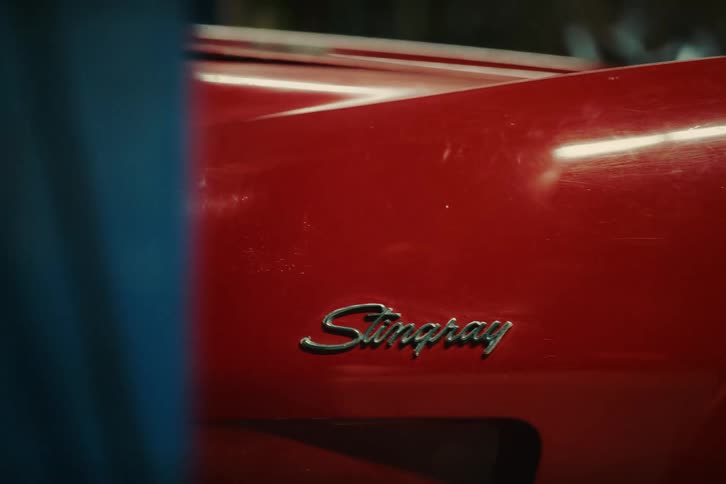 Classic red coupe car inside a garage