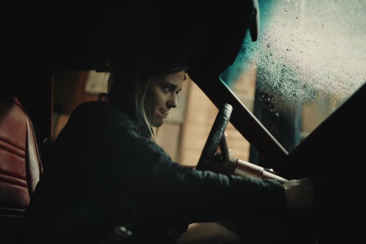Distressed woman inside a car trying to start it with the key becoming frustrated and giving up