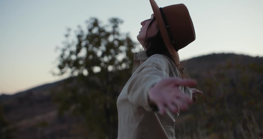 Woman in the midst of nature opening her arms