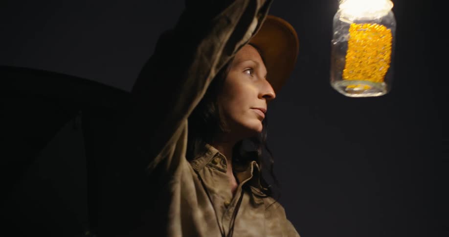 A woman camping in nature at night