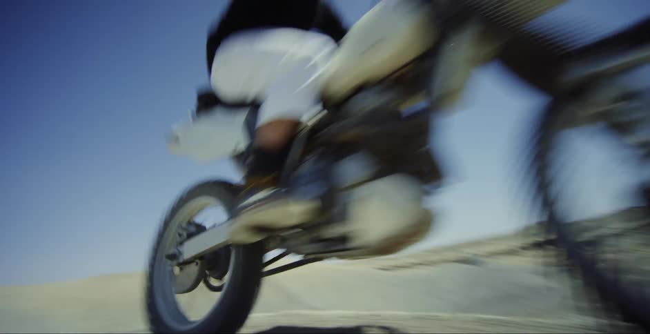 Man doing motocross through natural sand dunes