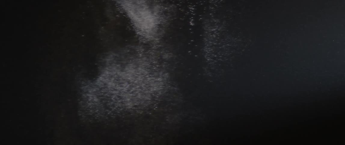 A spray of dust falls slowly