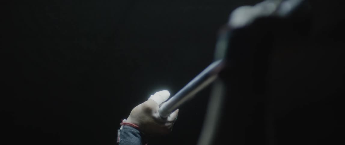 A man lifting a weight bar upward