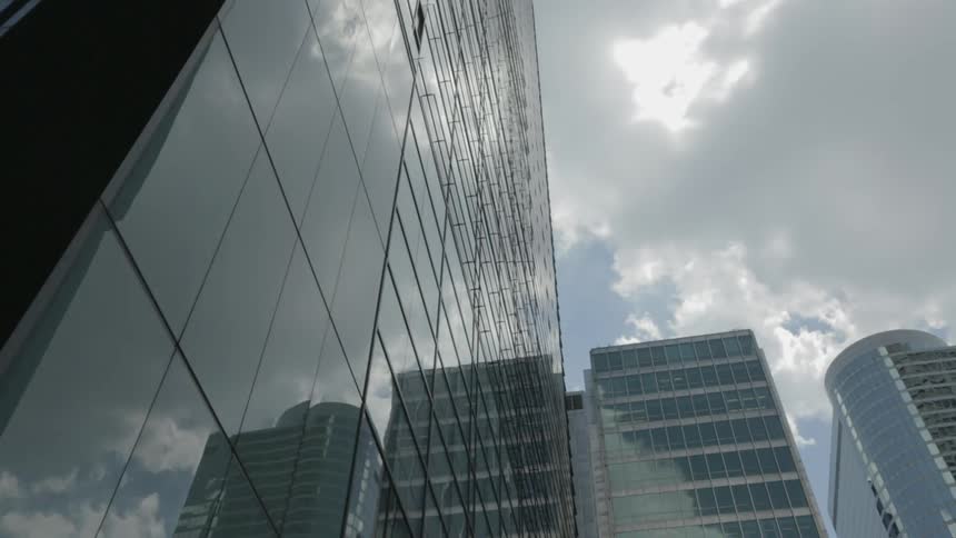 The clouds are floating past these buildings