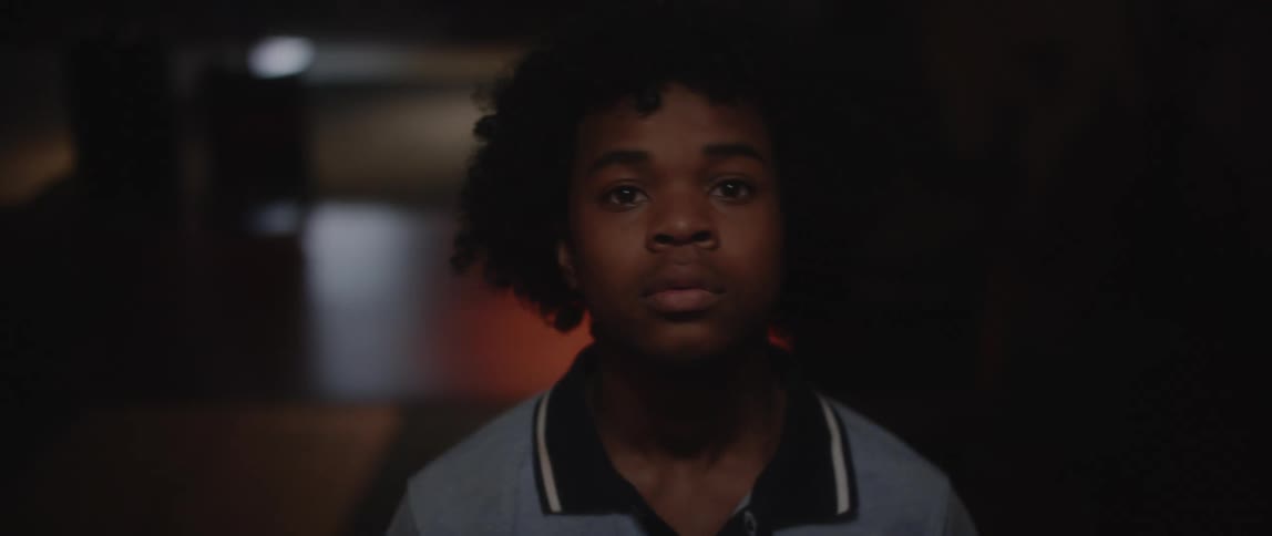 A clip of a black teen looking forward