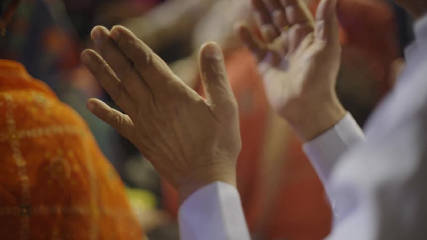 An old person clapping with his hands