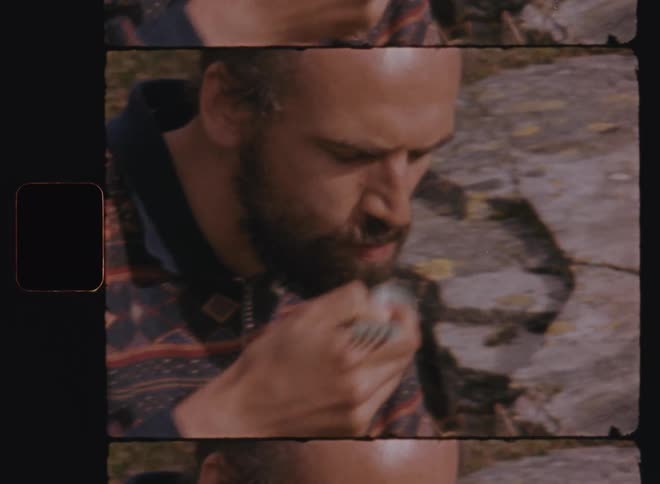 Man sitting and eating food with a small bowl