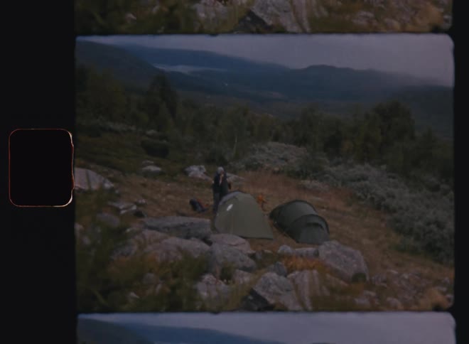 Landscape of a mountain with a person next to a tent