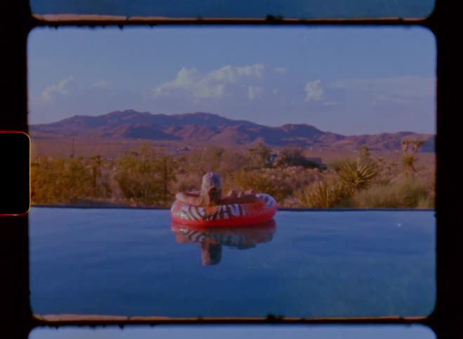 A person is floating in the lake on a tube
