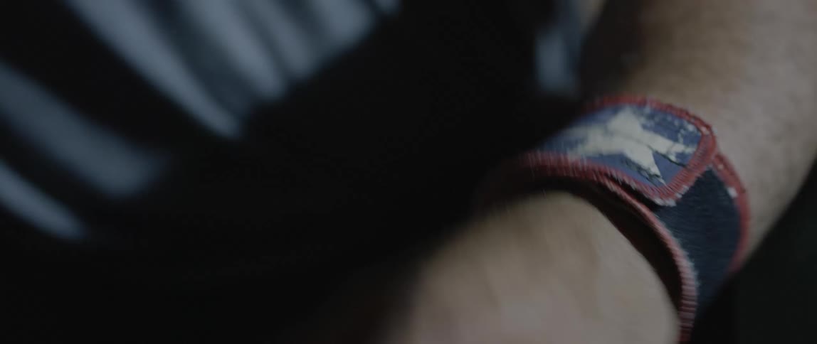 A clip of a person rolling a a tape on the wrist