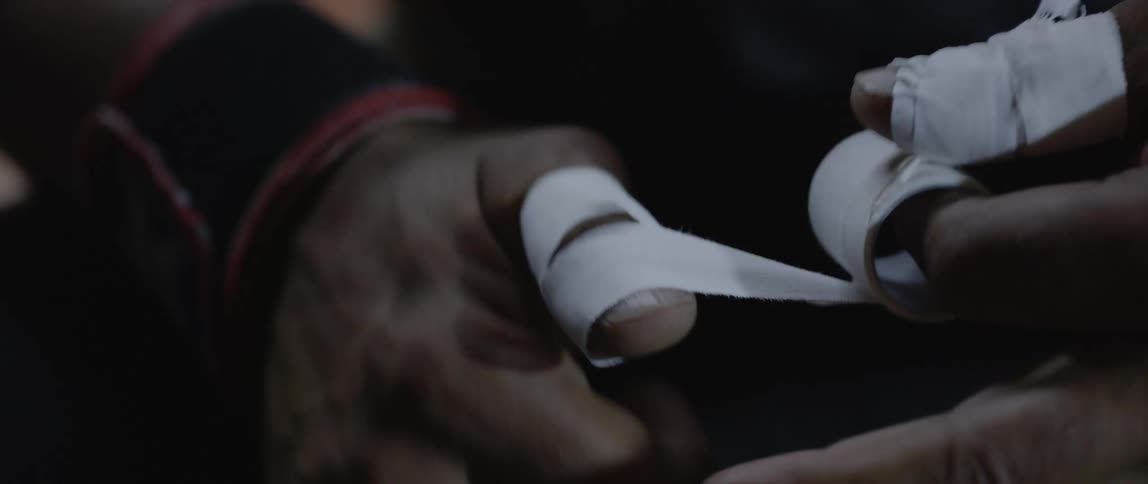 A person putting a tape on one of their fingers