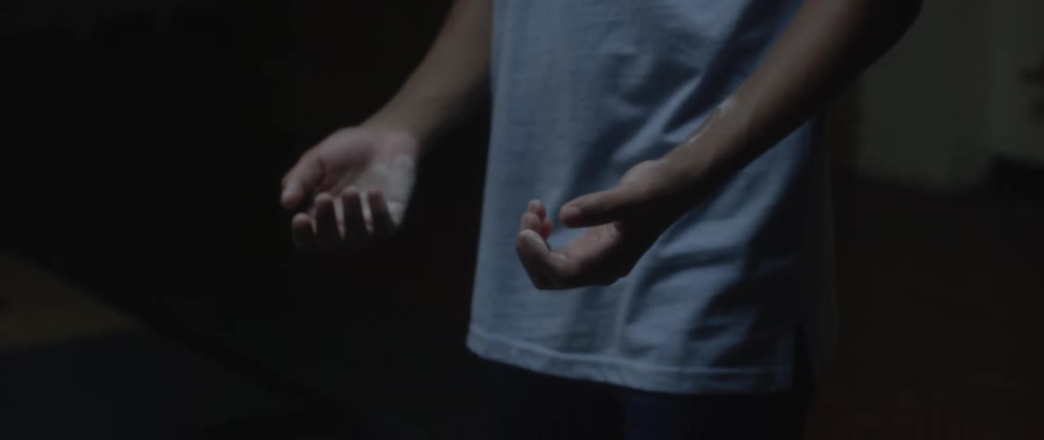 Closeup of a boys hands with magnesium inside a dark room