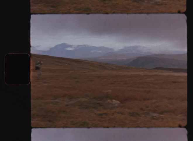 A clip of a person hiking the mountainous grass land